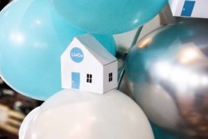 Mini white LivCo paper house sitting on white balloon at Ten Year Anniversary Party at The Elm