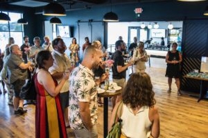 Guests holding drinks at LivCo’s Ten Year Anniversary Party at The Elm