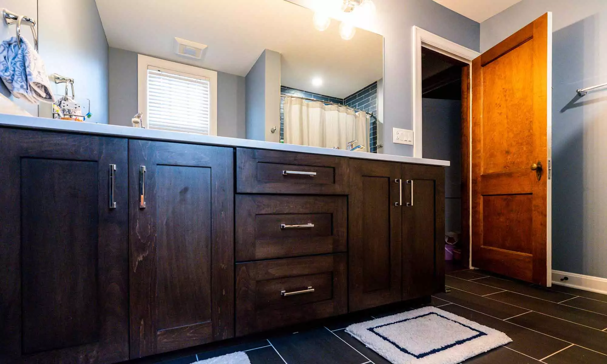 luxury bathroom remodel with dark wood vanity cabinets