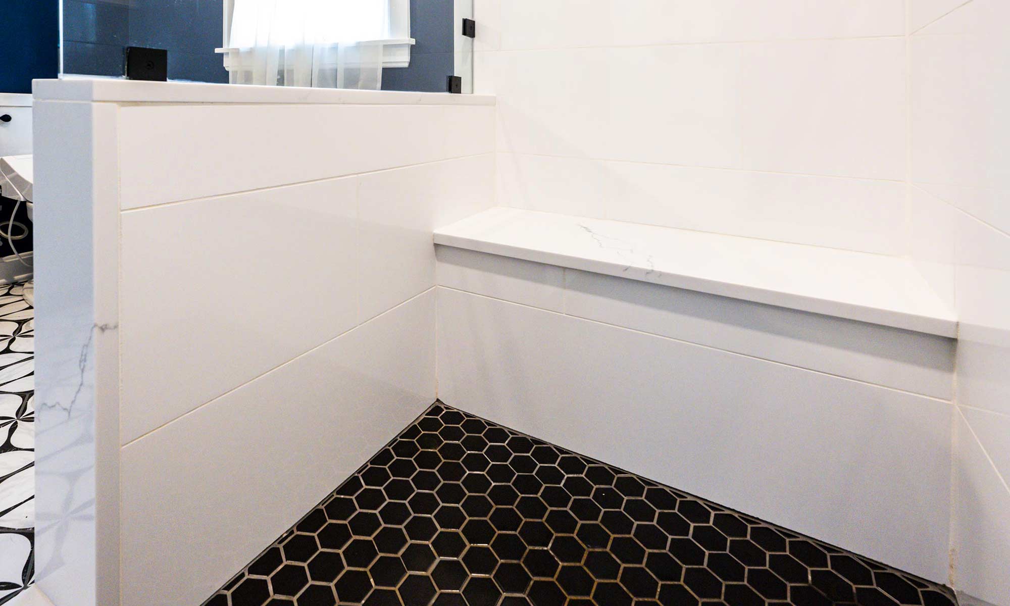 shower seat with hexagon floor tile in luxury bathroom remodel
