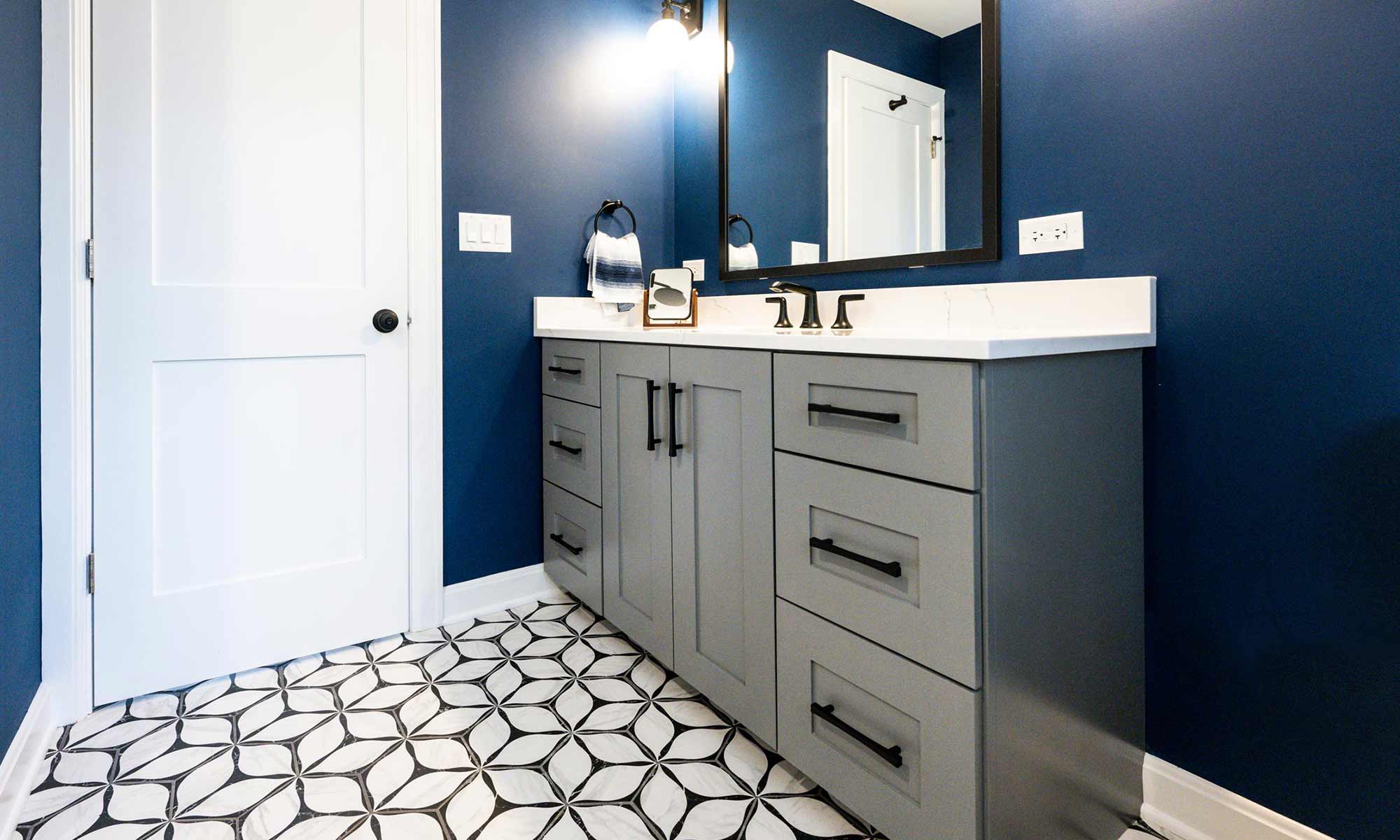 luxury bathroom remodel with grey cabinets and blue walls