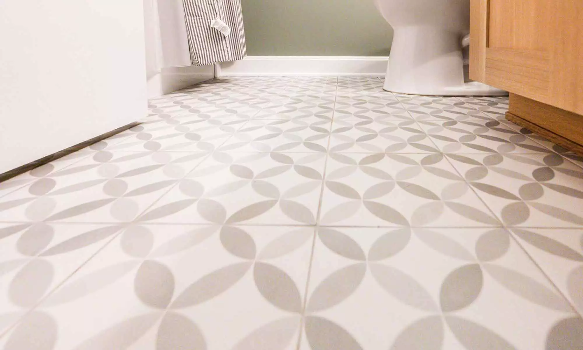 grey patterned tile with white oak vanity basement bathroom remodel