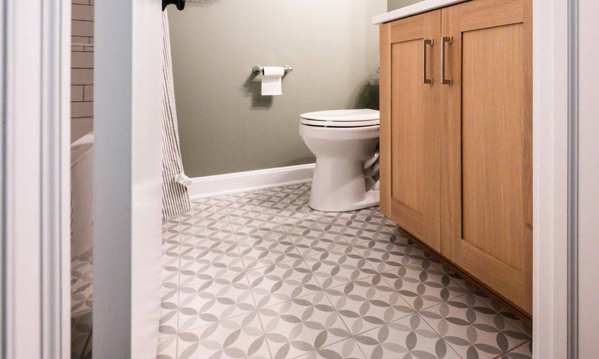 grey patterned tile with white oak vanity basement bathroom remodel