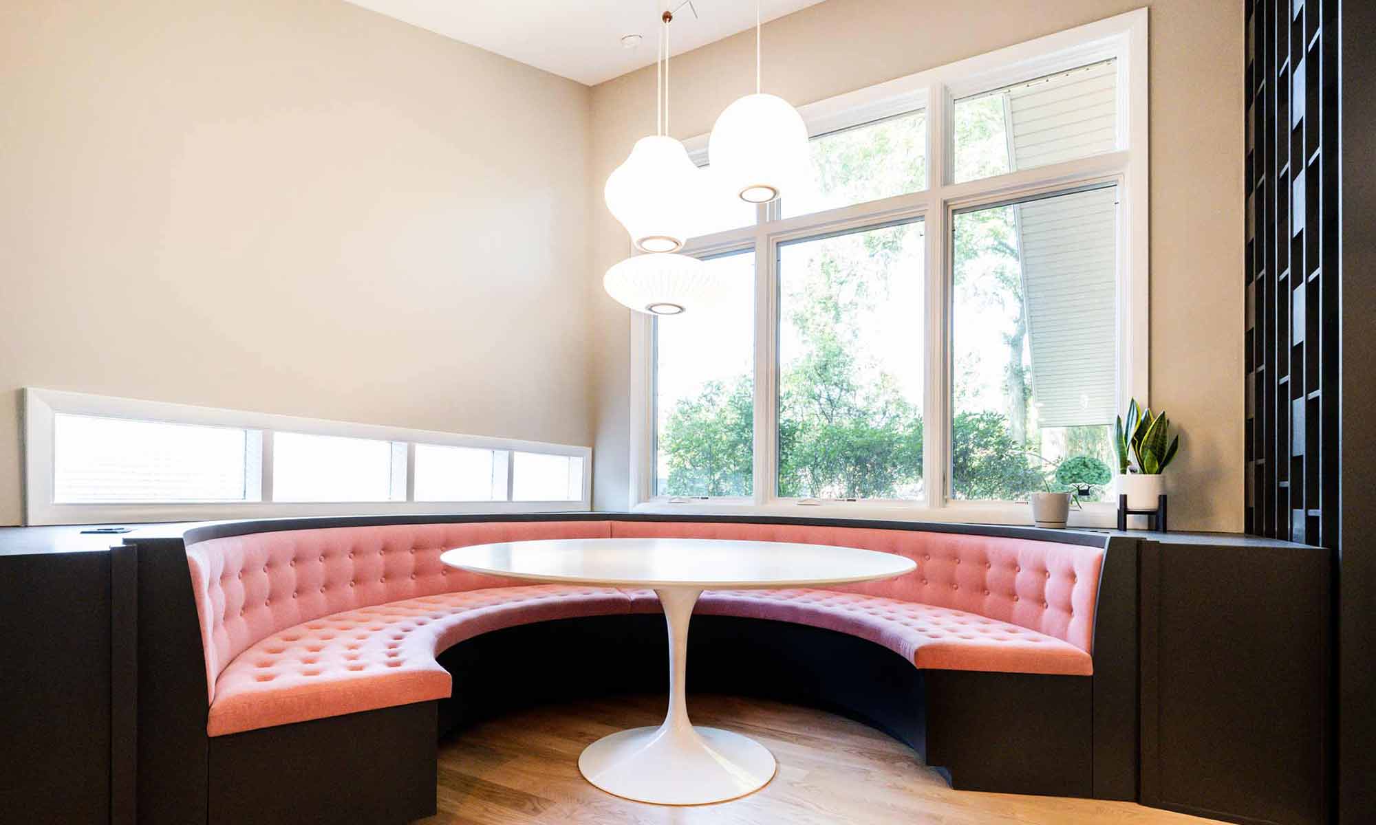 custom round booth banquette seating with pink cushions in luxury mid century remodel