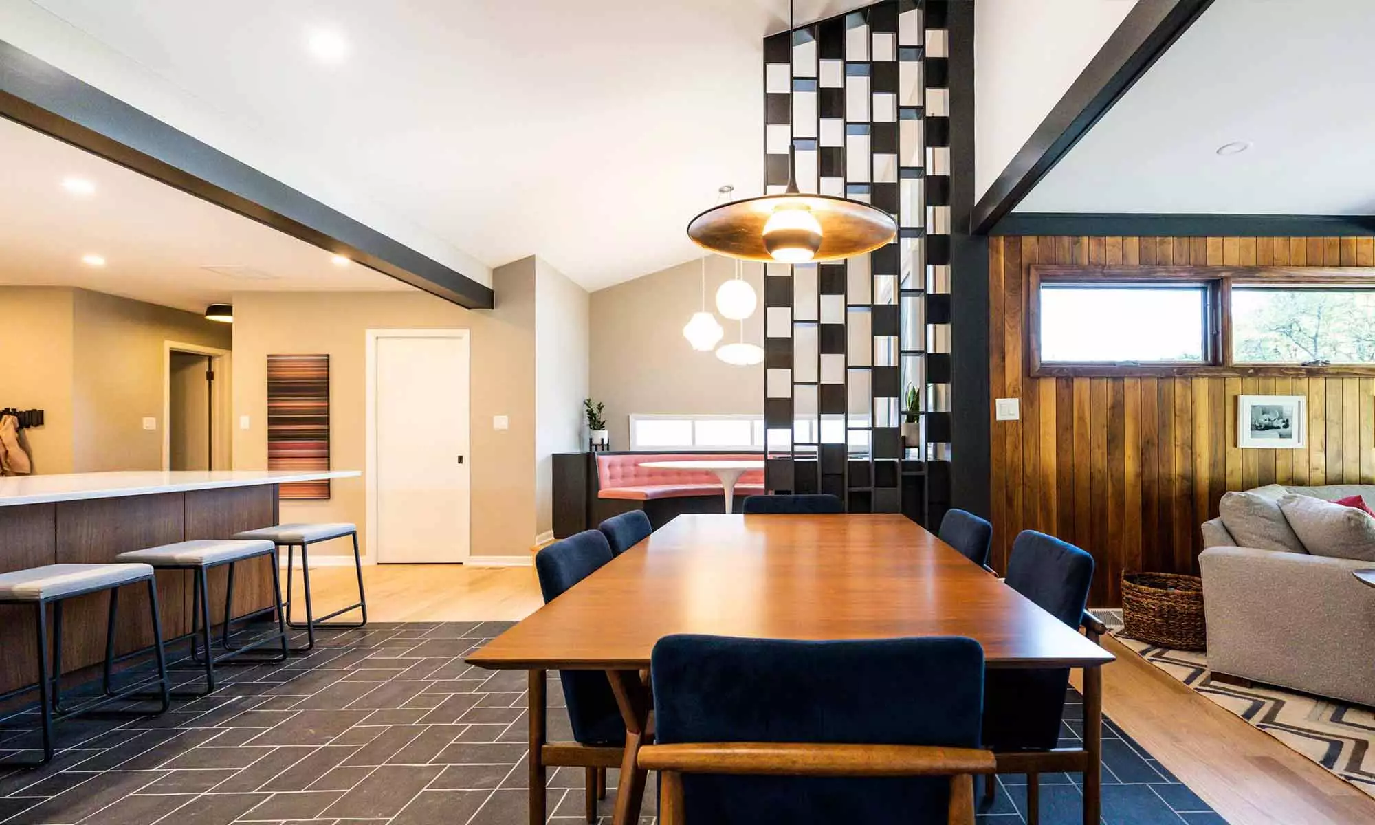 luxury mid century remodel dining space with artistic feature wall