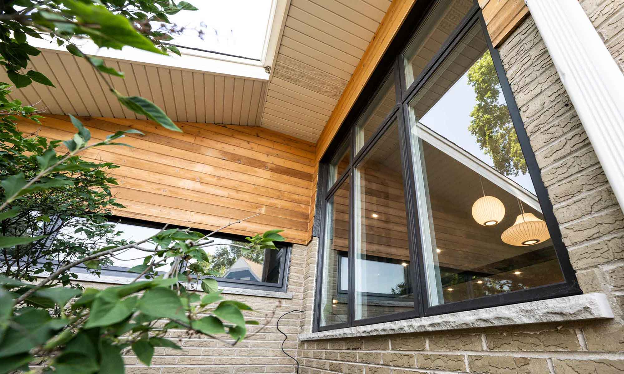 exterior view of new windows with cedar siding and brick