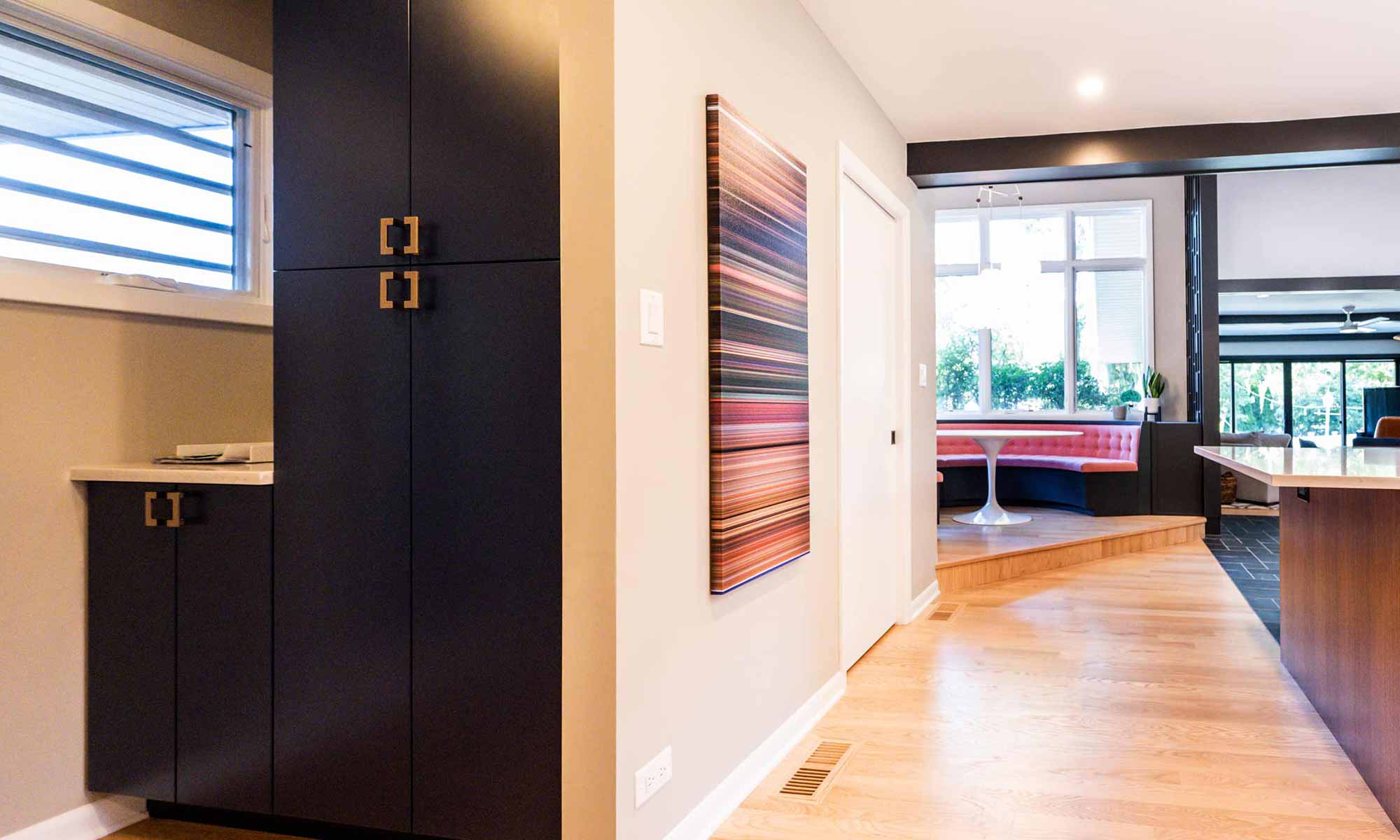 view of pantry cabinets and round banquette seating beyond