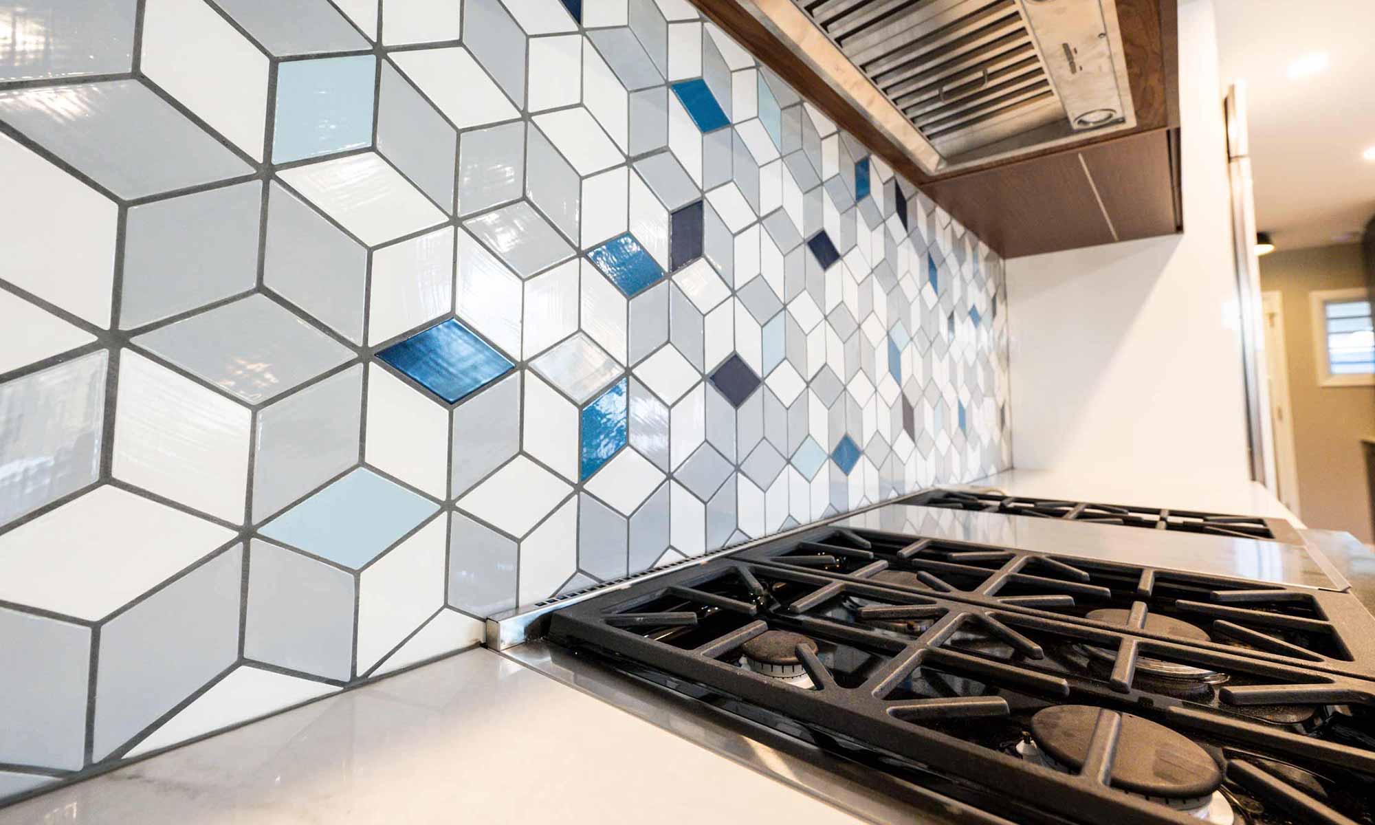 closeup view of geometric grey and blue kitchen backsplash tile