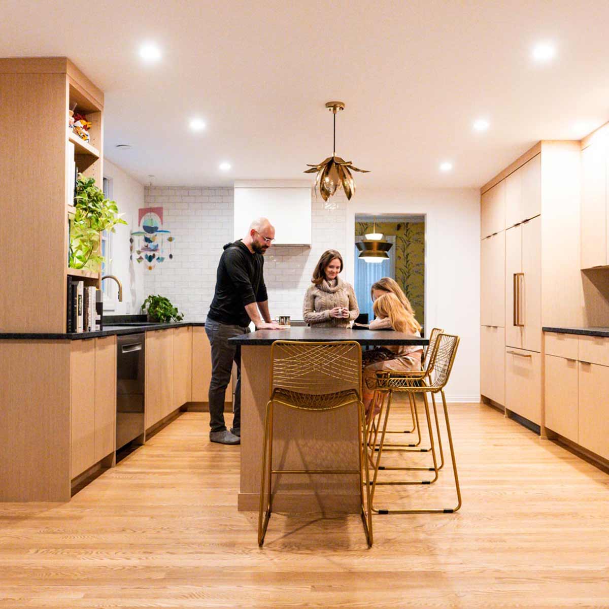 family in luxury kitchen remodel in Riverside, IL featuring a social kitchen island in white oak