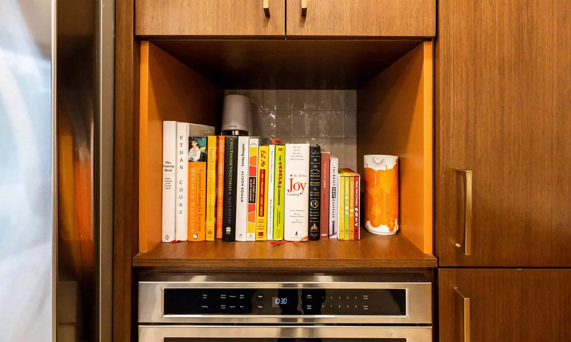 built-in walnut shelves with cookbooks in luxury mcm kitchen remodel in Riverside IL