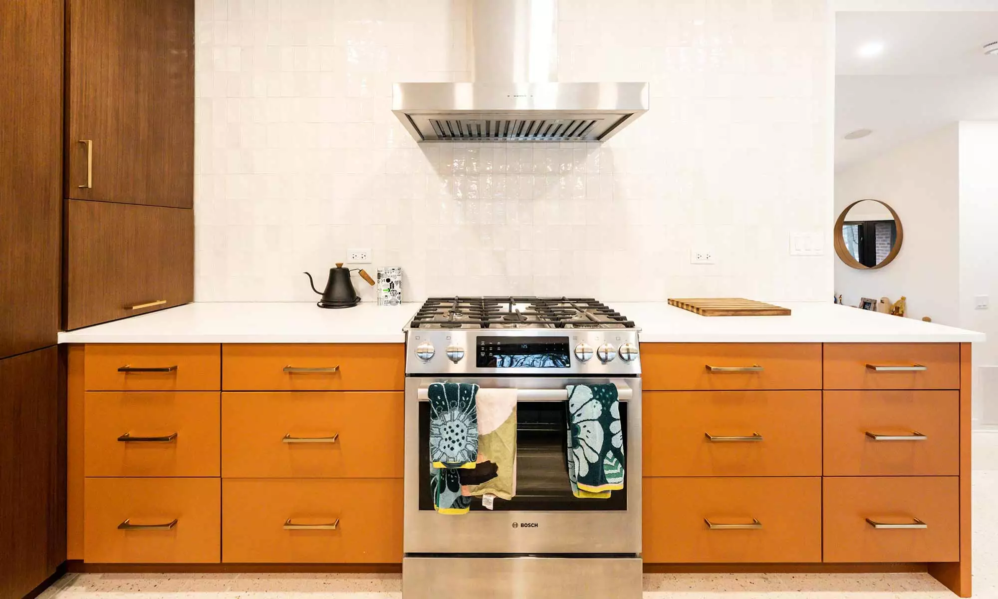 Mid century modern luxury kitchen remodel in Riverside IL by LivCo with blue island orange perimeter cabinets walnut tall cabinets and terrazzo flooring