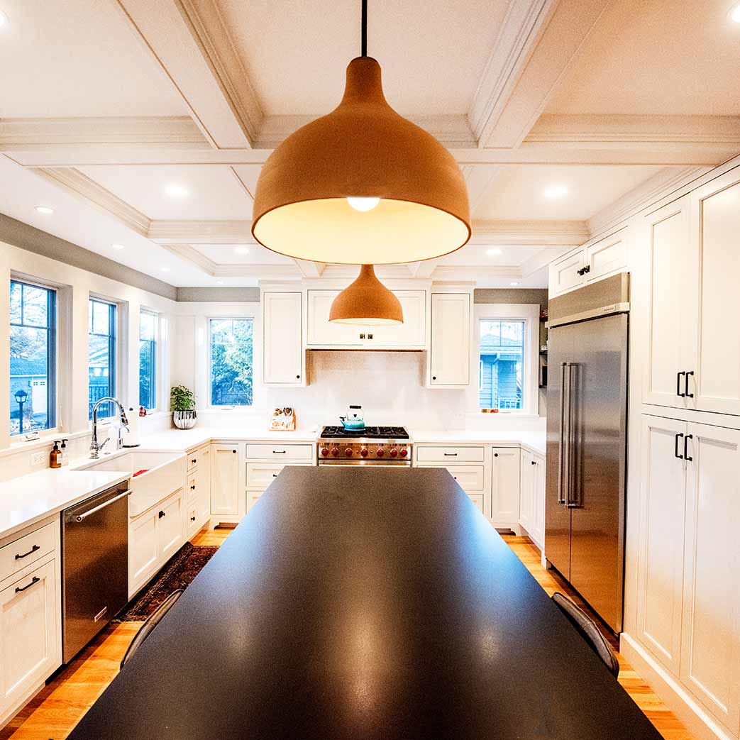 luxury kitchen remodel in glen ellyn with coffered ceilings and black island countertops