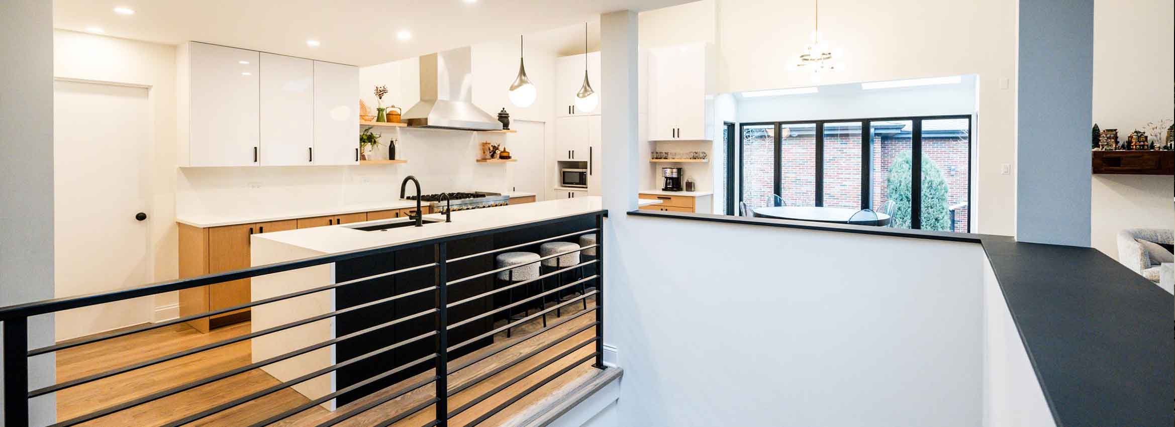 open plan modern kitchen remodel in indian head park illinois with vaulted ceilings and metal railing