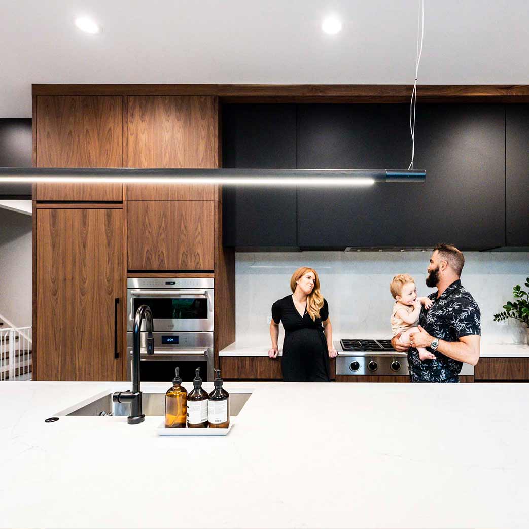 young family holding baby in luxury modern kitchen remodel in hinsdale illinois