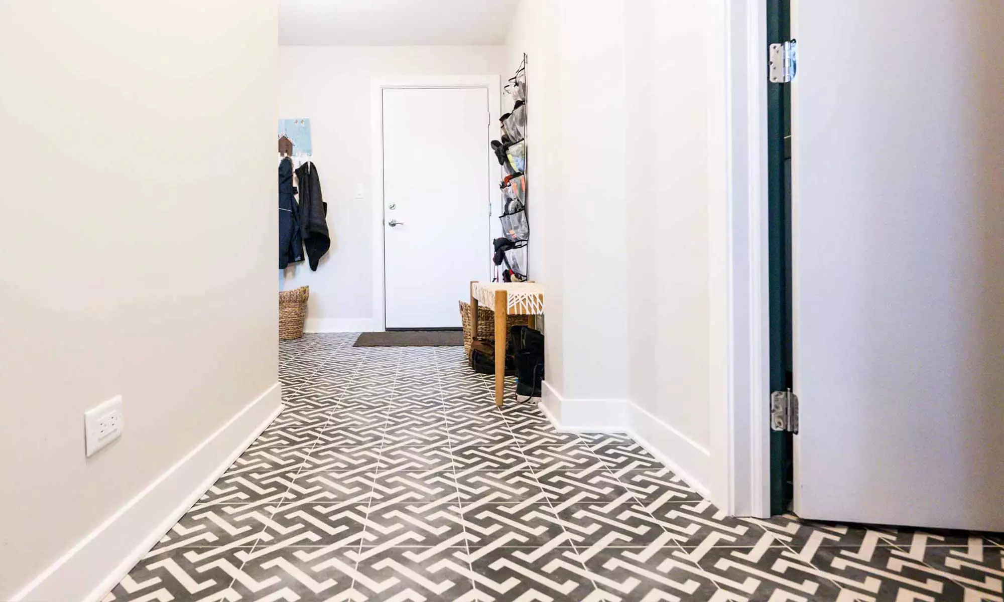 mudroom with patterned black and white tile in luxury whole house remodel