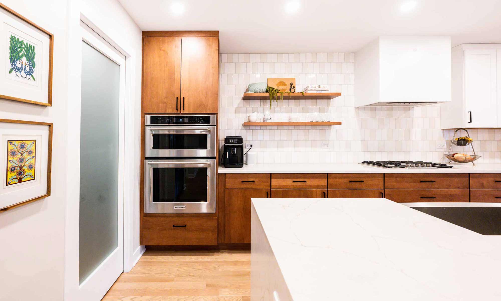 view towards ovens of modern kitchen remodel with wood and white cabinets in western springs