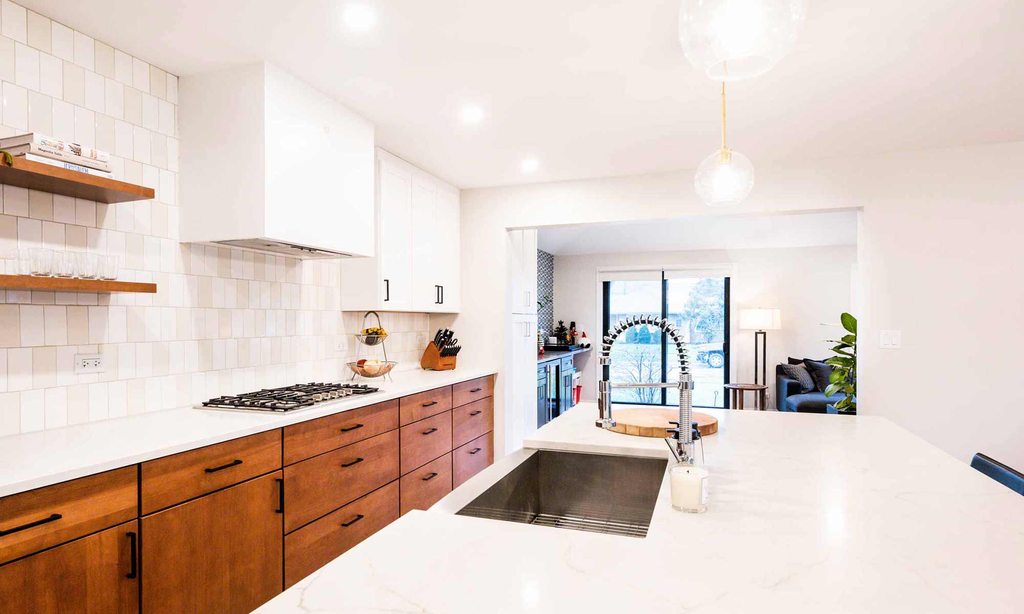 view towards family room of modern kitchen remodel with wood and white cabinets in western springs