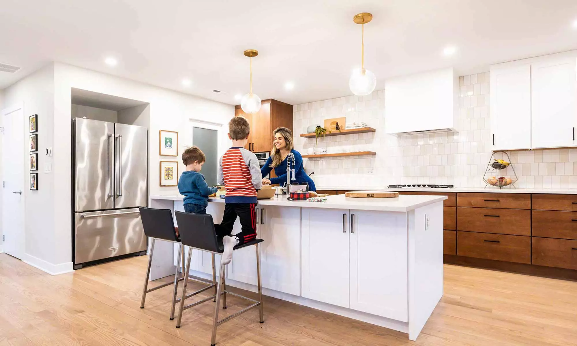 family gathered around kitchen island in modern western springs remodel and addition