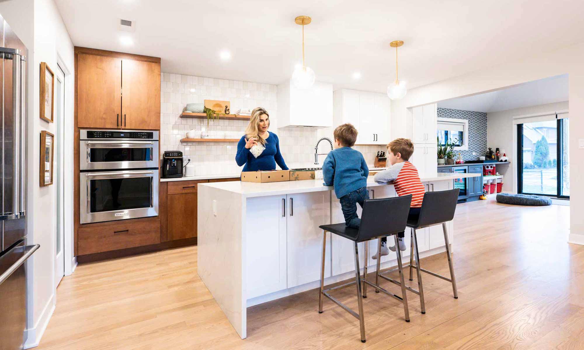 family gathered around kitchen island in modern western springs remodel and addition
