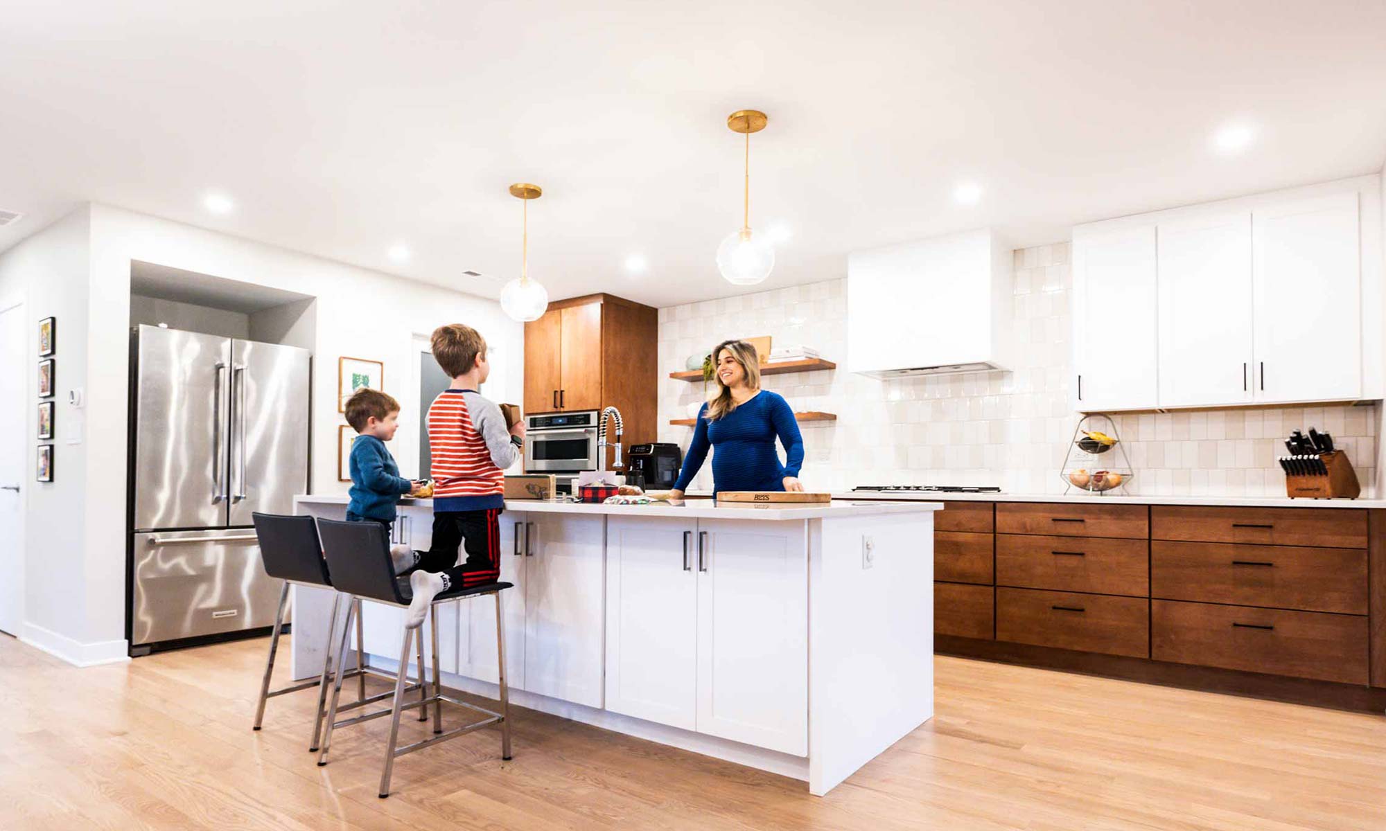 family gathered around kitchen island in modern western springs remodel and addition