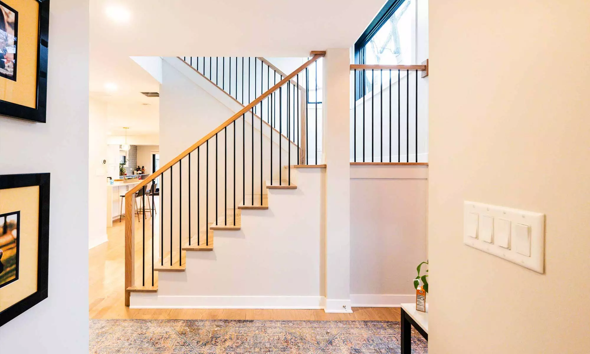 white oak stairway viewed from entrance hall in luxury second floor addition with oak and metal modern railing