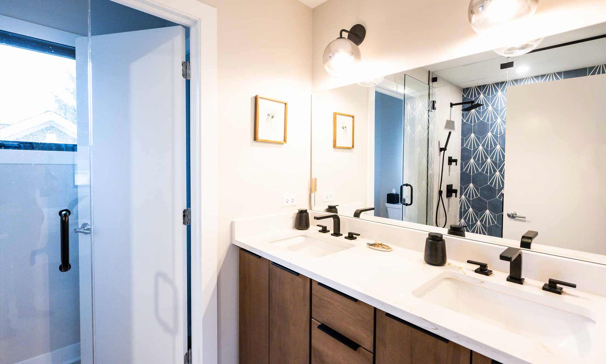 double vanity in wood with black fixtures in luxury western springs remodel and addition