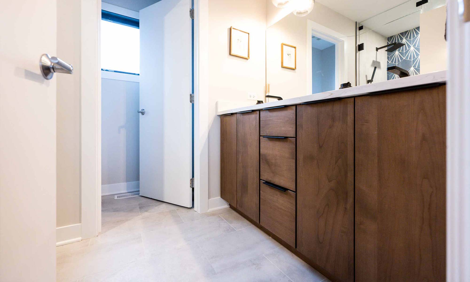 double vanity in wood with black fixtures in luxury western springs remodel and addition