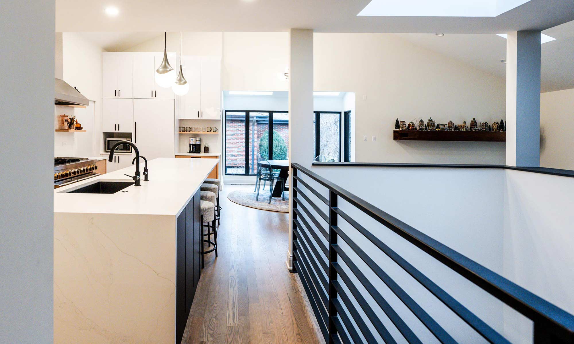 Indian Head Park luxury kithcen remodel by LivCo featuring wood, black, and gloss white modern cabinetry view from kitchen entrance