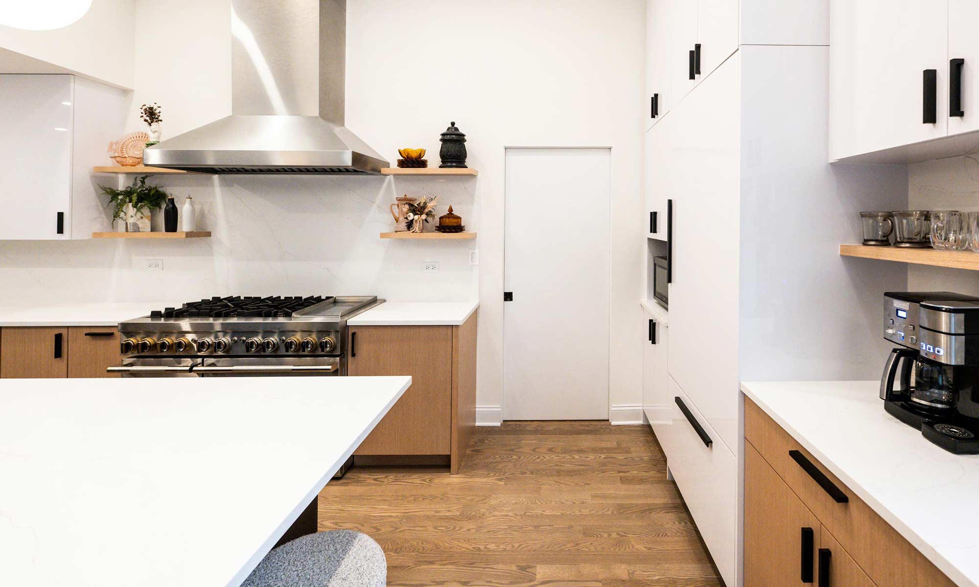 Indian Head Park luxury kithcen remodel by LivCo featuring wood, black, and gloss white modern cabinetry