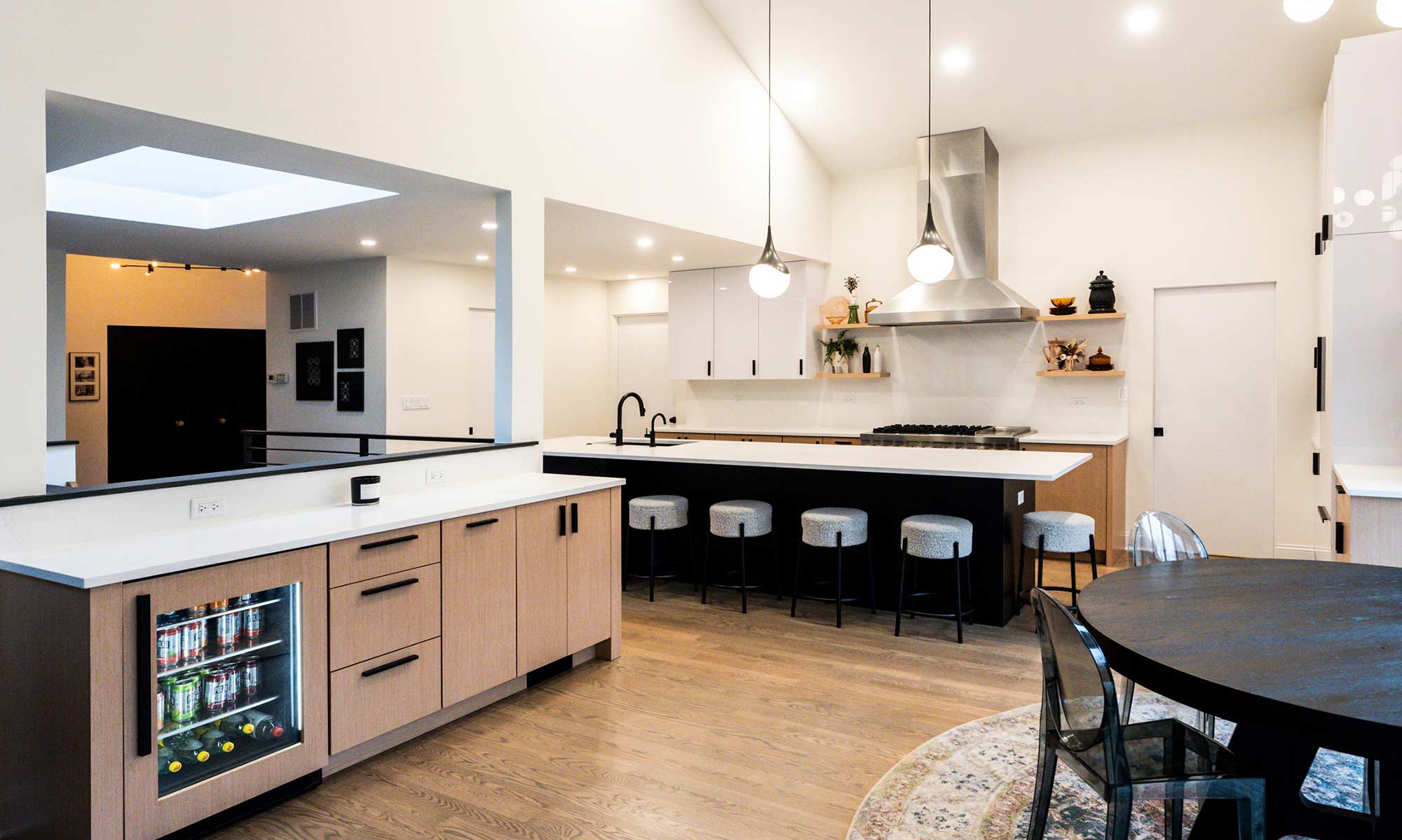 Indian Head Park luxury kithcen remodel by LivCo featuring wood, black, and gloss white modern cabinetry