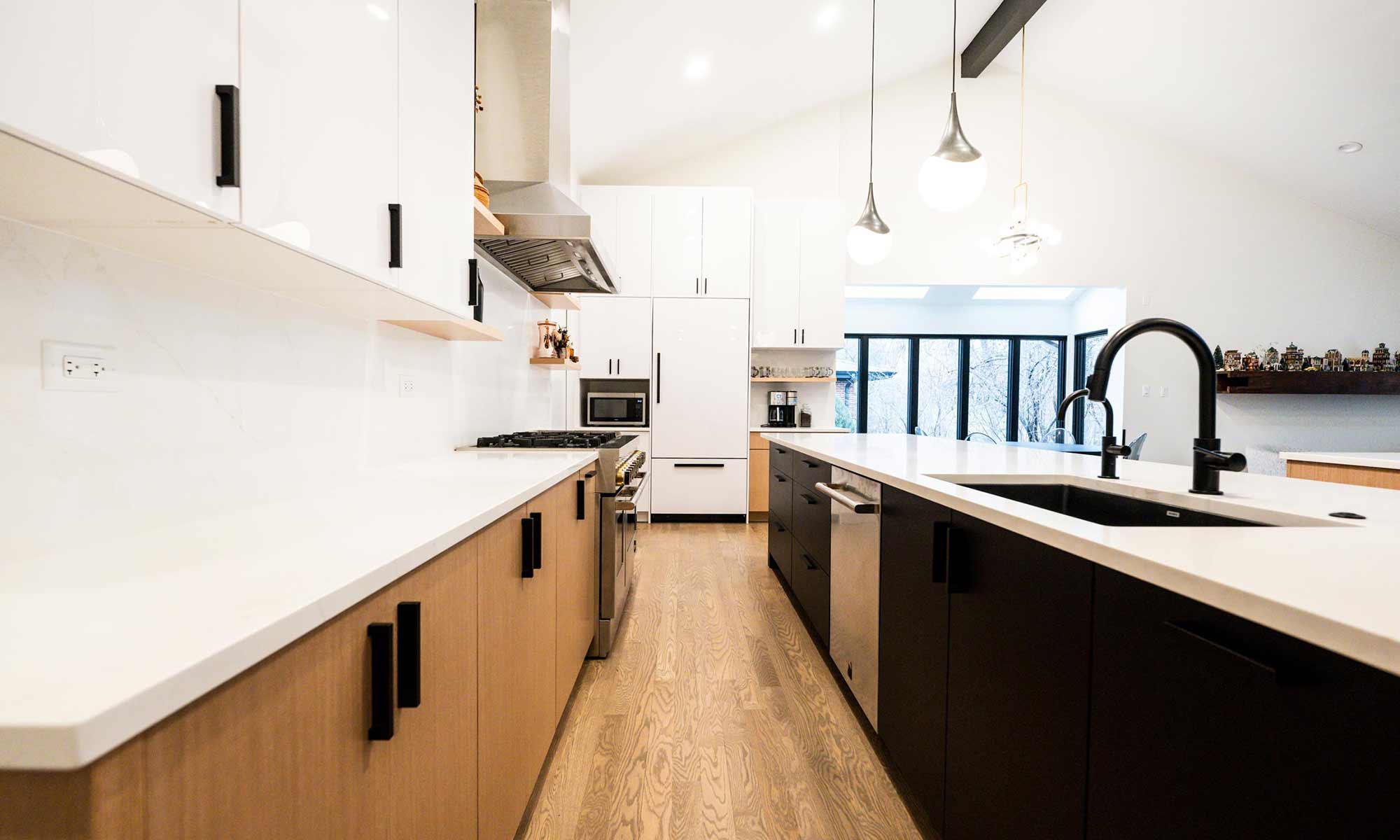 Indian Head Park luxury kithcen remodel by LivCo featuring wood, black, and gloss white modern cabinetry