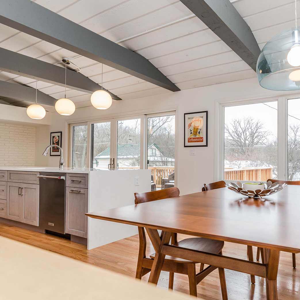 kitchen and breakfast room mcm remodel with vaulted ceilings and doors to back deck