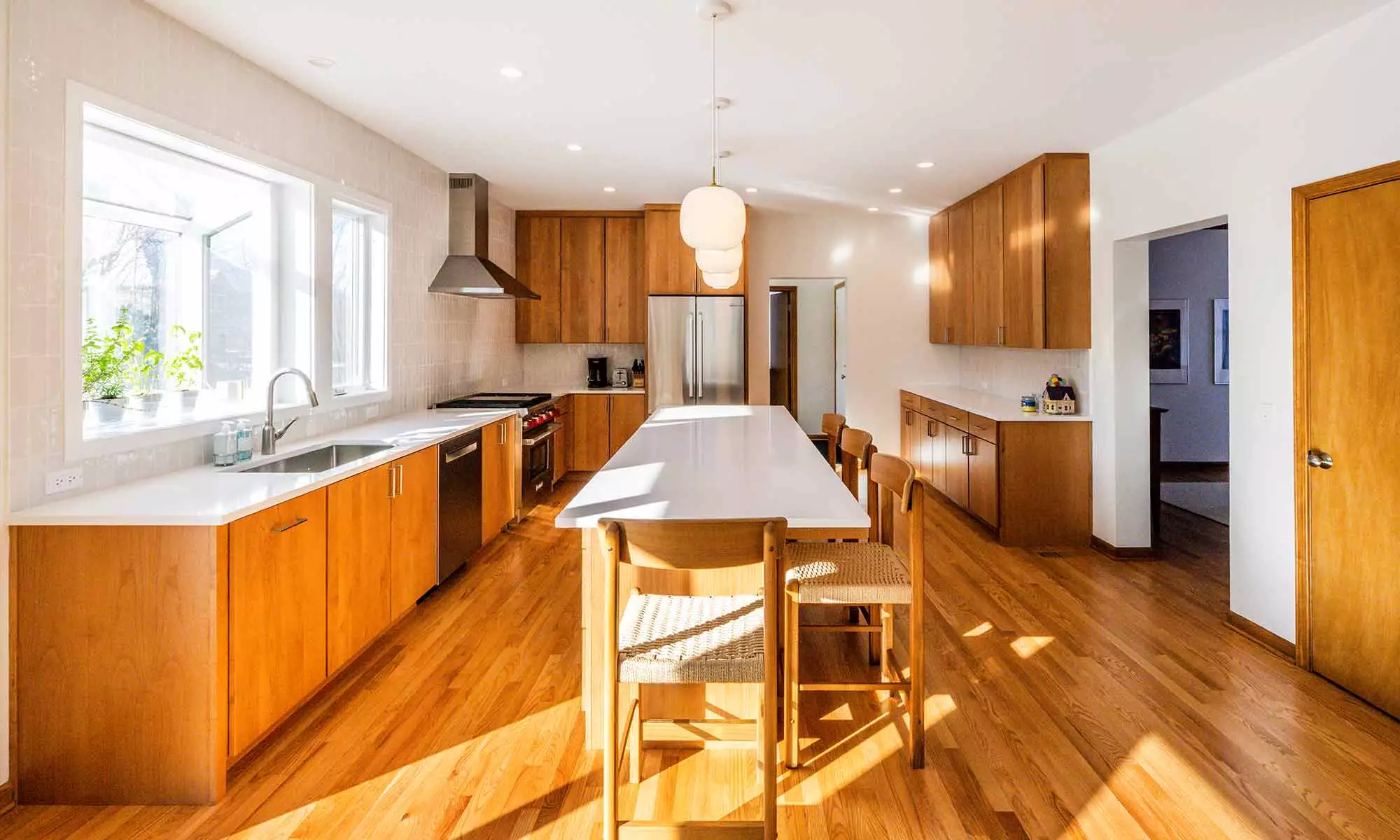 modern kitchen remodel with cherry cabinets open plan and white quartz island countertop