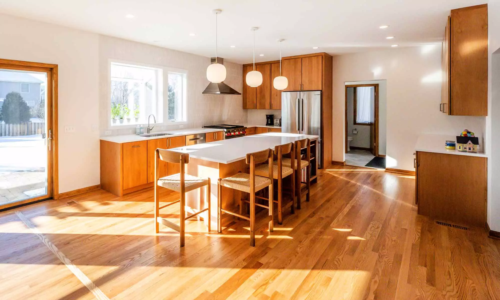 modern kitchen remodel with cherry cabinets open plan and white quartz island countertop