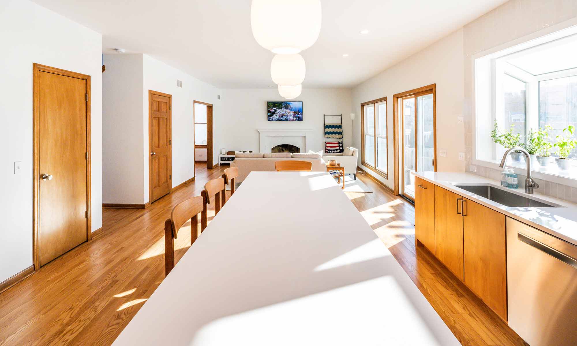 modern kitchen remodel with cherry cabinets open plan and white quartz island countertop