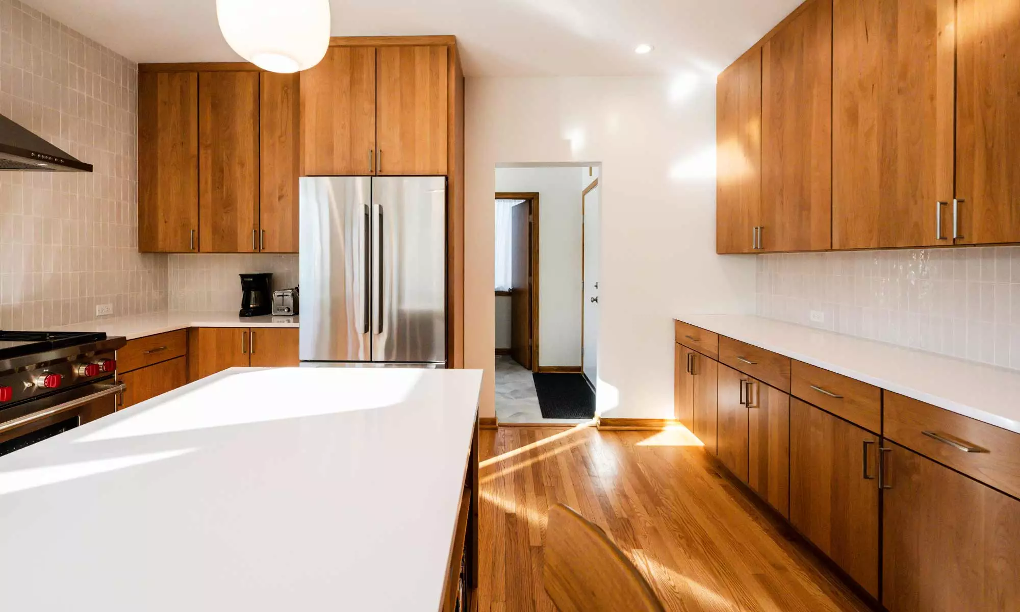 modern kitchen remodel with cherry cabinets open plan and white quartz island countertop