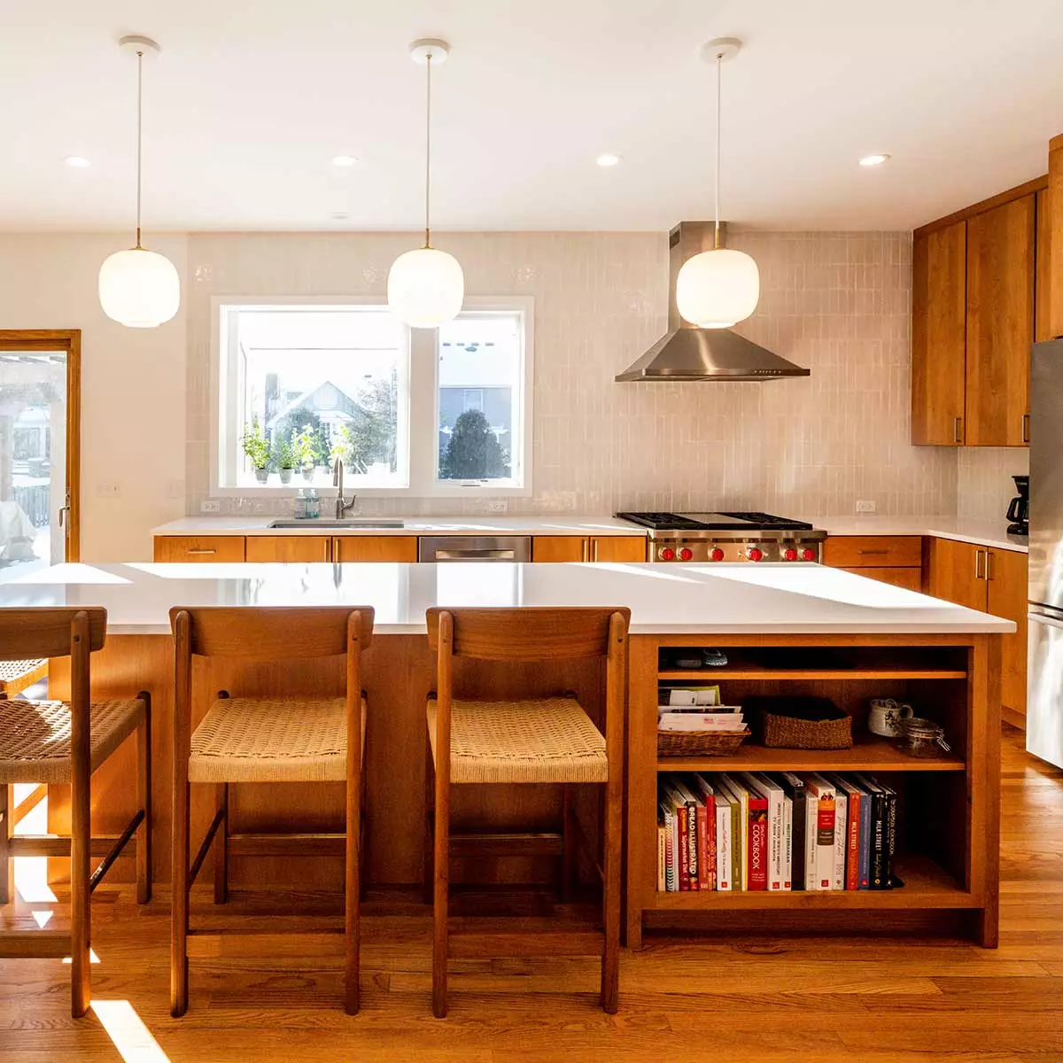 modern kitchen remodel with cherry cabinets open plan and white quartz island countertop