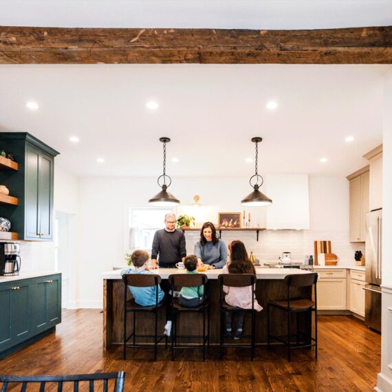 family gathered around a kitchen island in la grange park Illinois vintage kitchen remodel