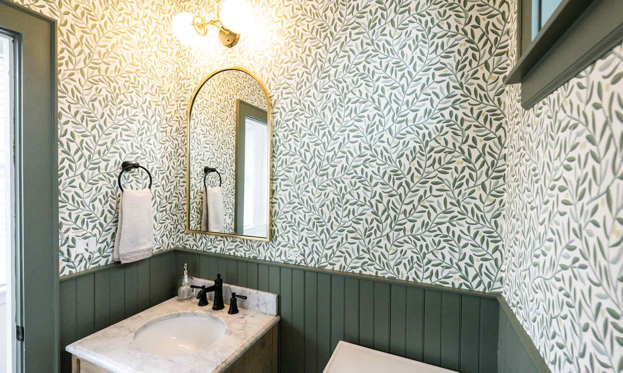 vintage powder room remodel with pattern hexagon tile green wainscoting and wallpaper