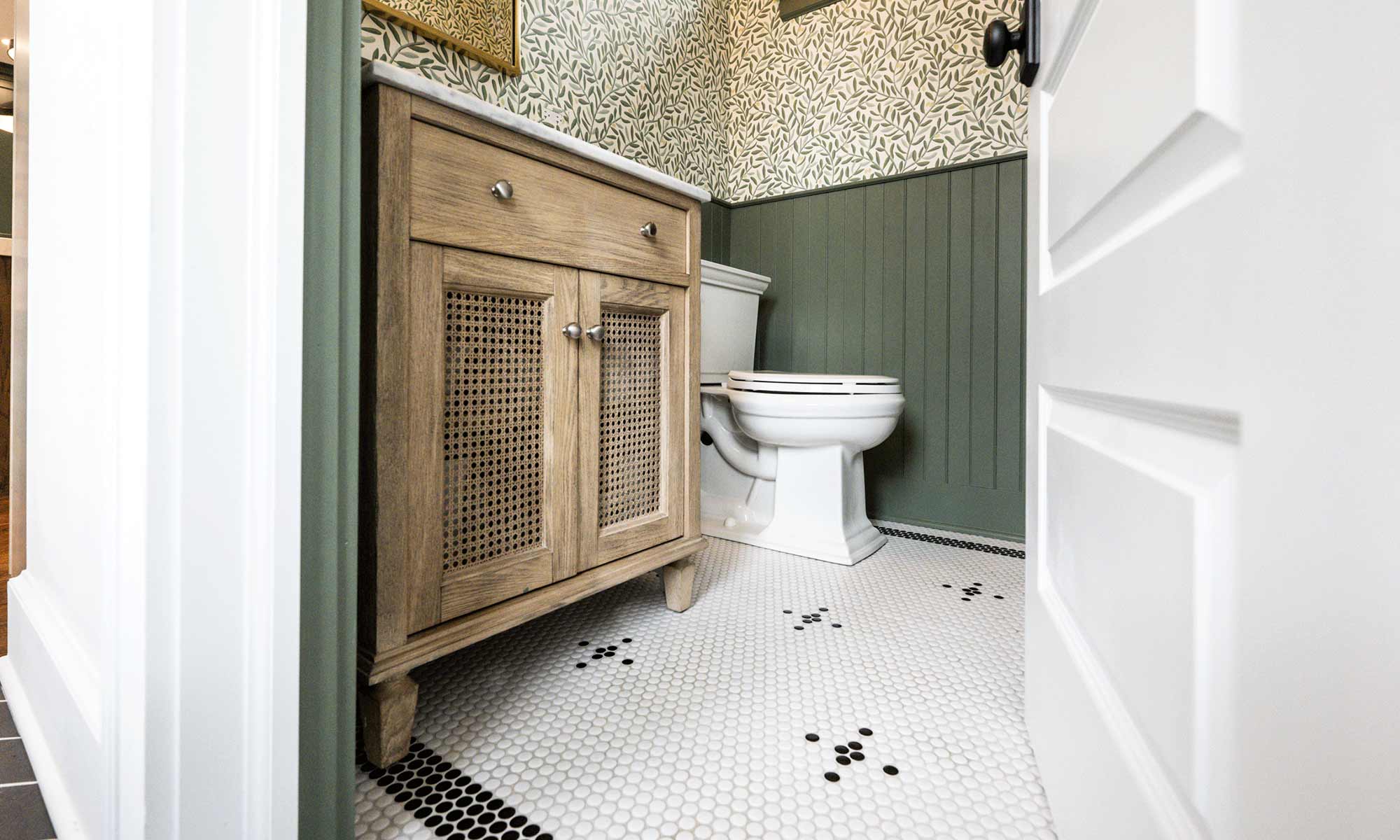 vintage powder room remodel with pattern hexagon tile green wainscoting and wallpaper