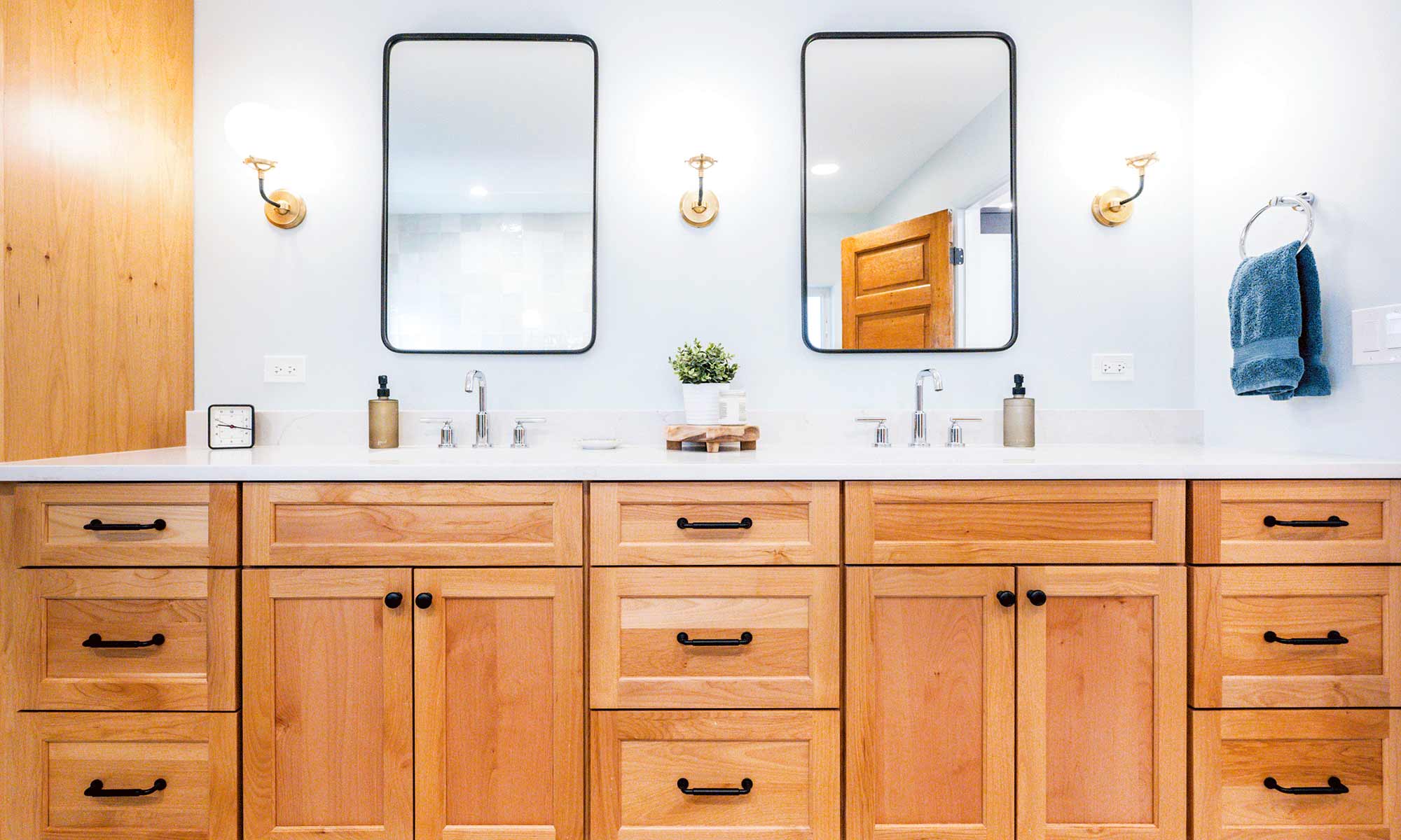 luxury bathroom remodel with light wood cabinets and marble tile and vintage mirrors in la grange park