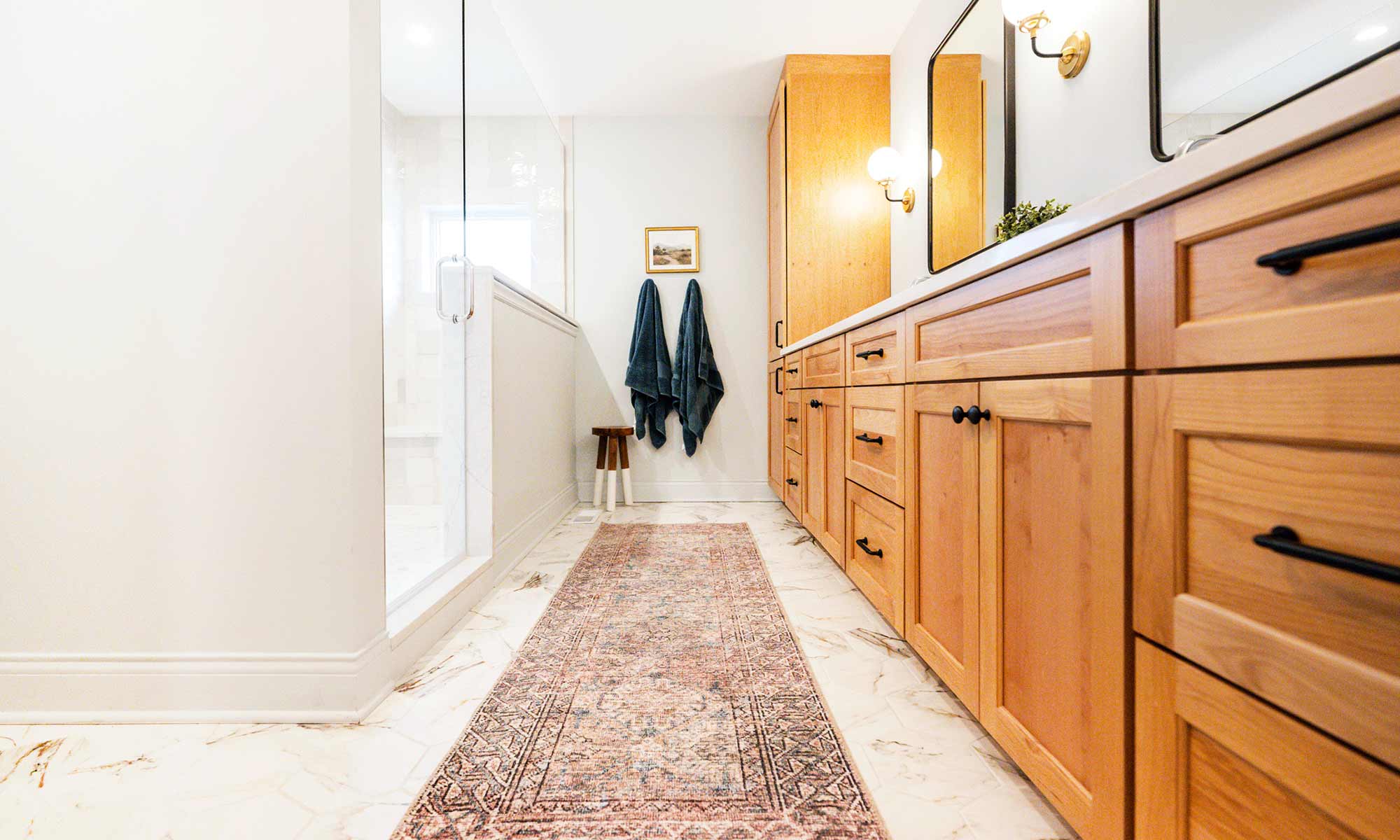 luxury bathroom remodel with light wood cabinets and marble tile in la grange park