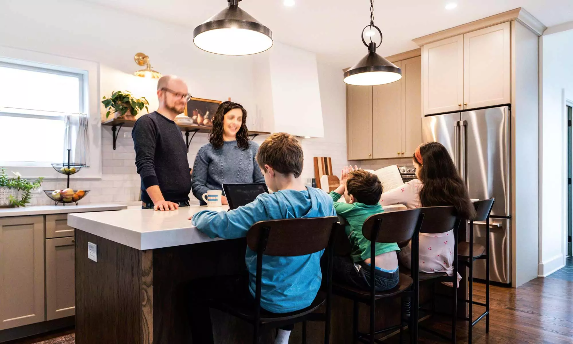 family gathered around a kitchen island in la grange park Illinois vintage kitchen remodel