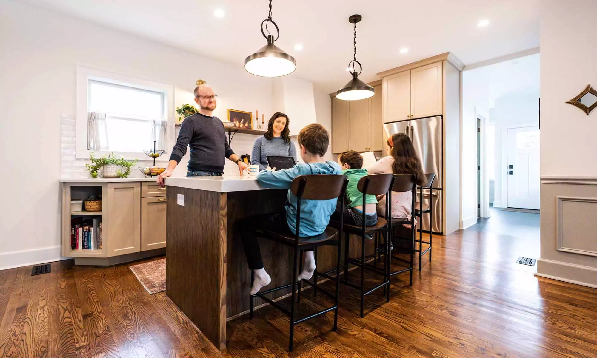 family gathered around a kitchen island in la grange park Illinois vintage kitchen remodel