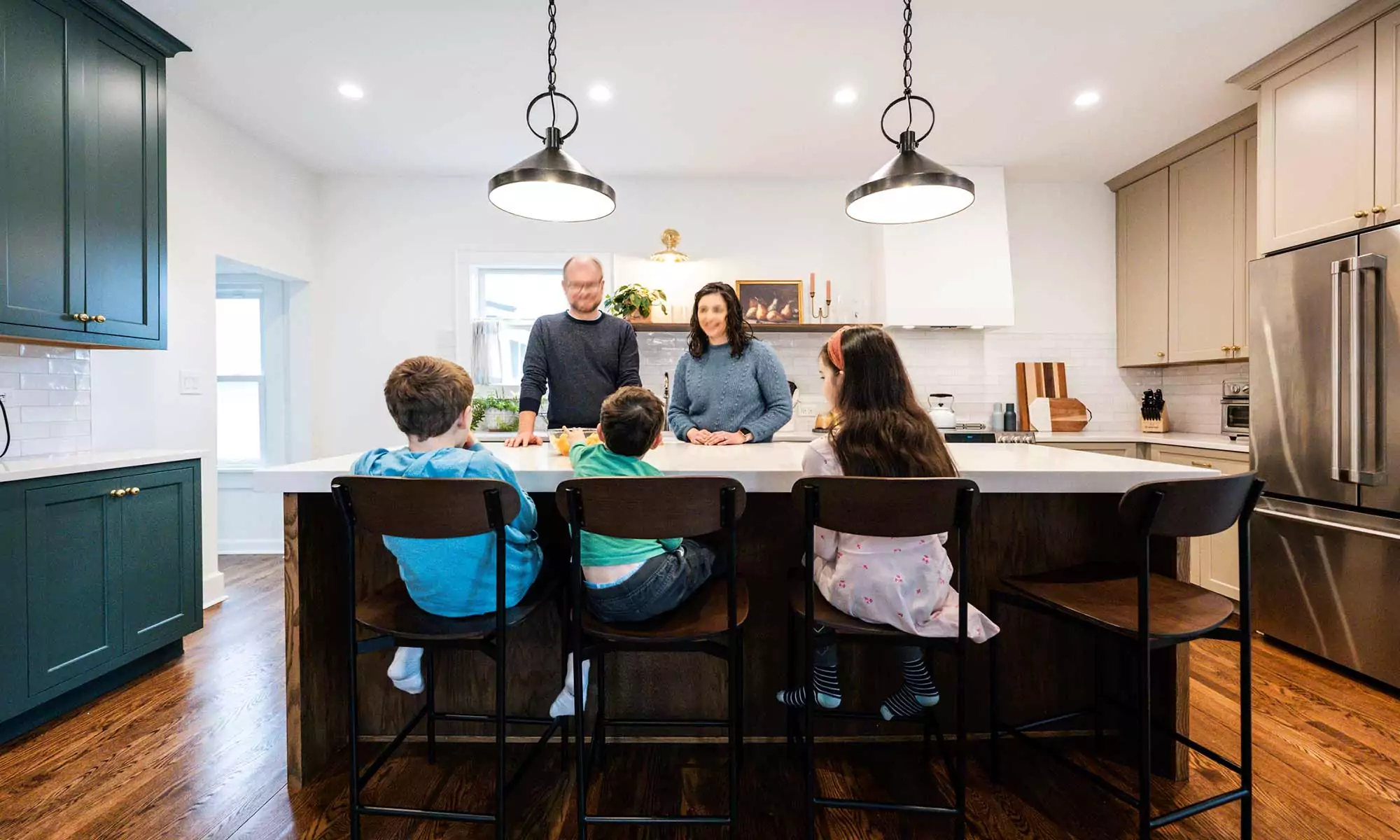 family gathered around a kitchen island in la grange park Illinois vintage kitchen remodel