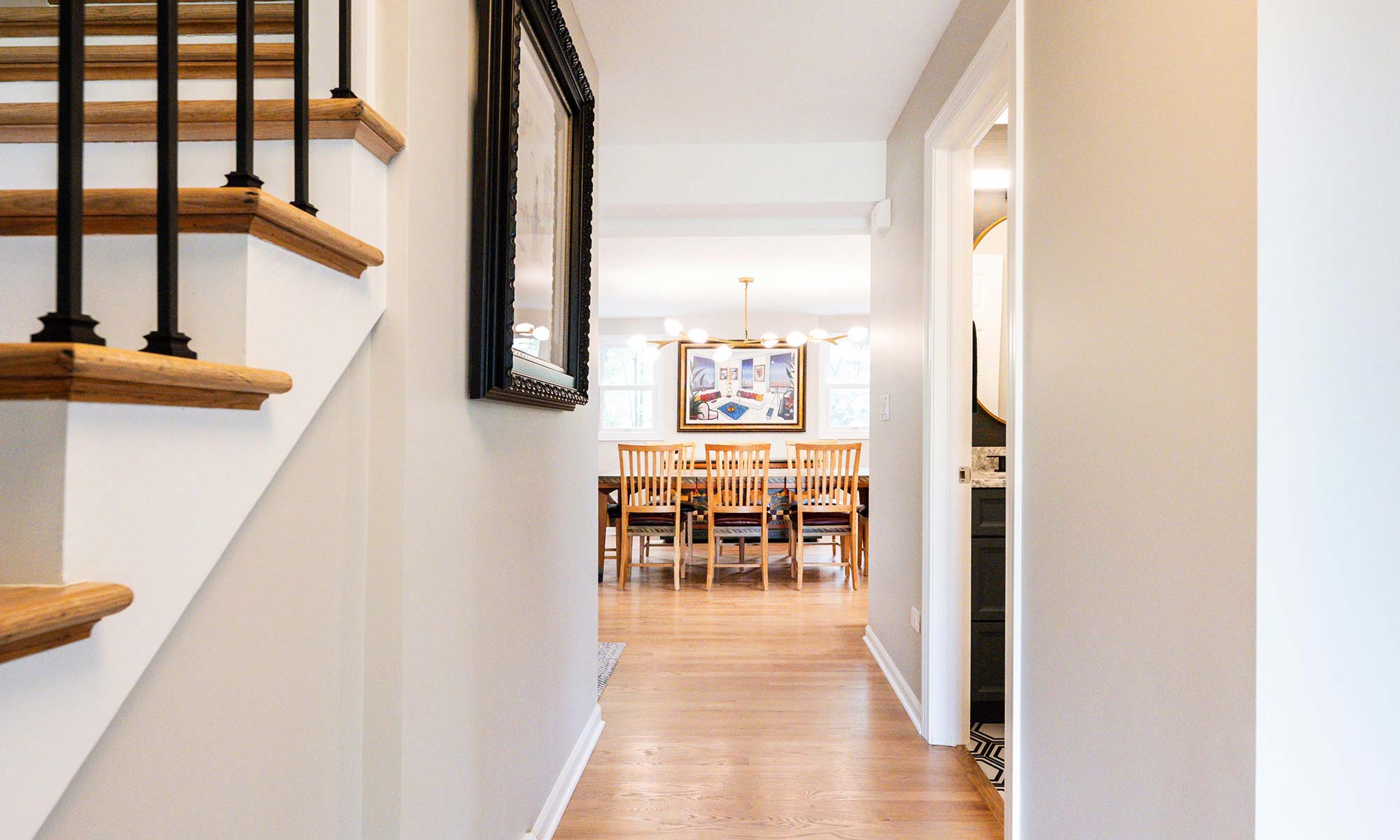 A hallway with a dining table and chairs