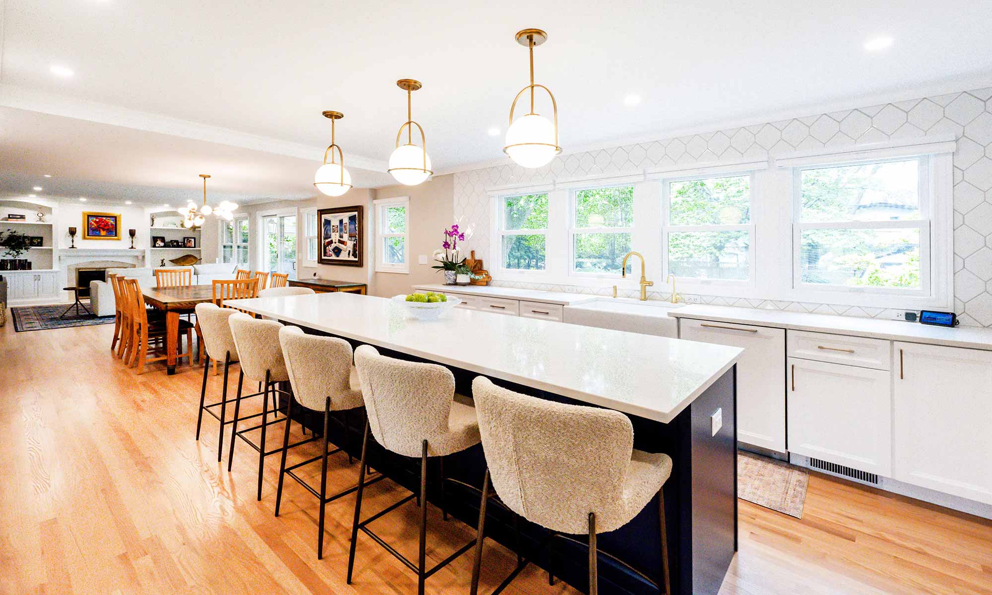 A kitchen with a large island and chairs