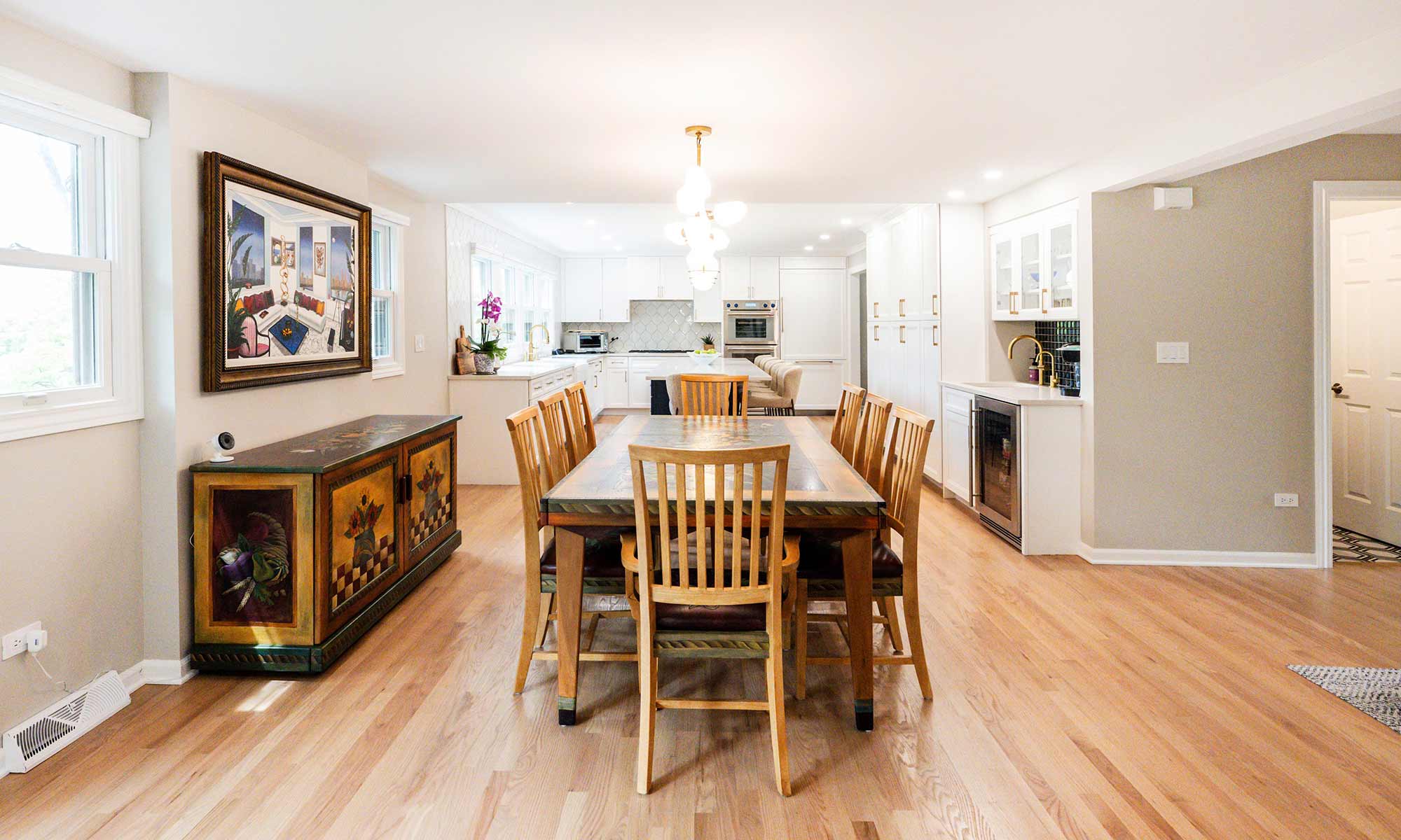 A dining room and kitchen with a table and chairs