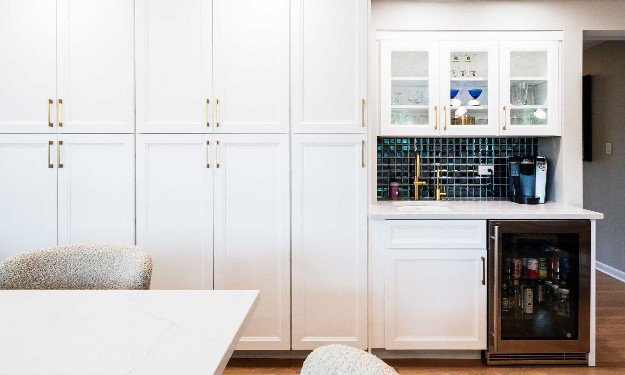 A kitchen with white cabinets and a table