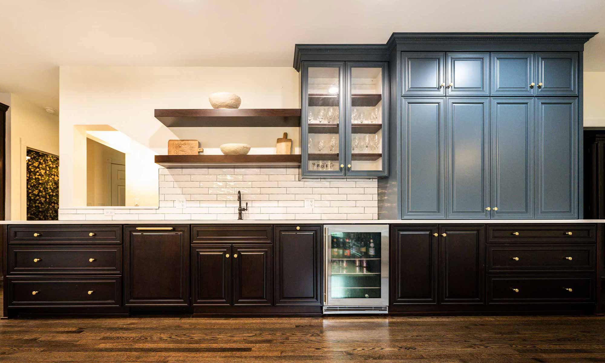brown and slate blue kitchen bar cabinets with beverage fridge and open shelves